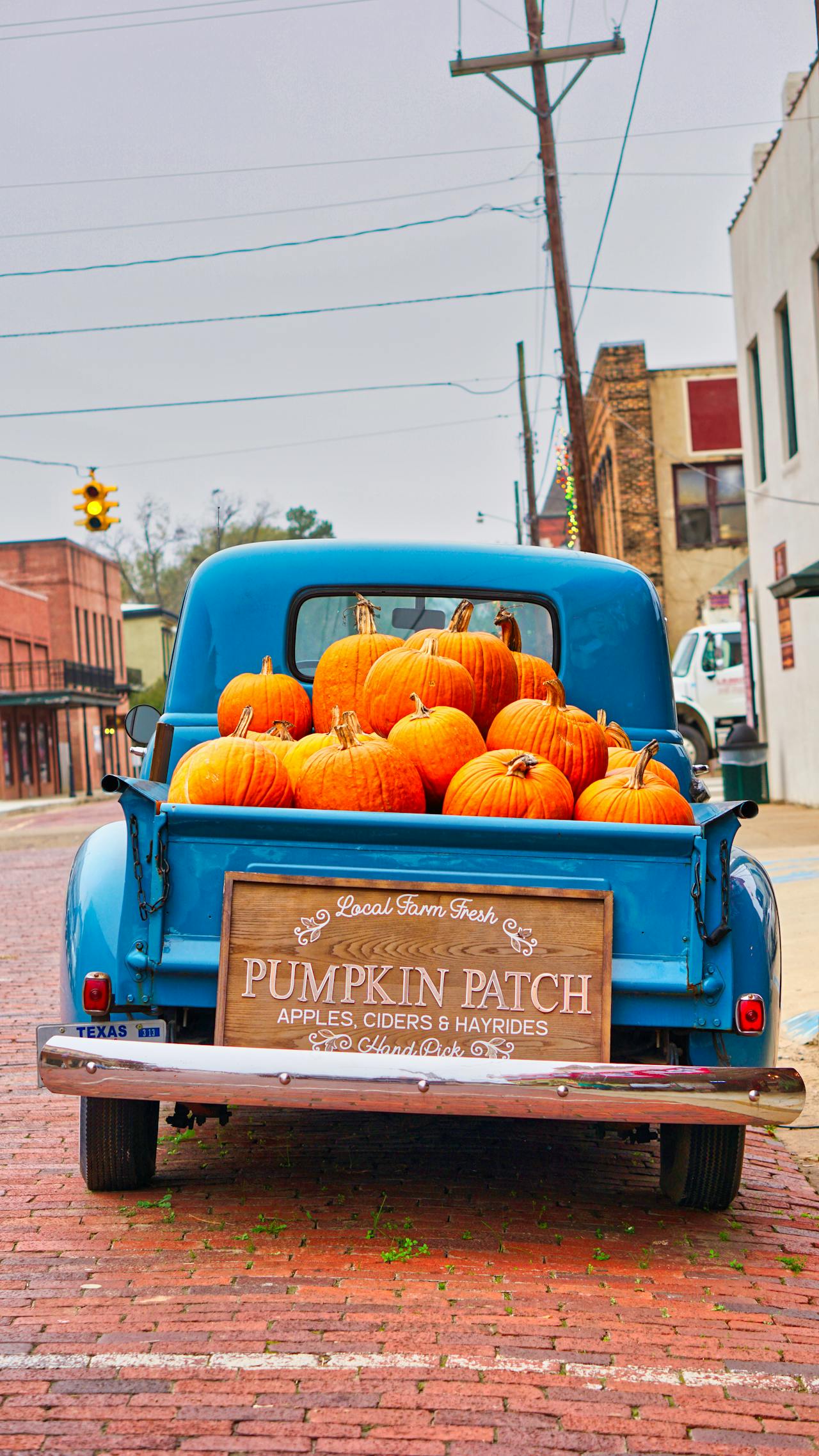 Pumpkin-filled vintage truck on the brick streets of Jefferson in October